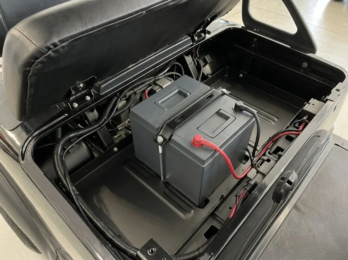 Battery compartment of an E-Z-GO with a lithium pack on the flat tray